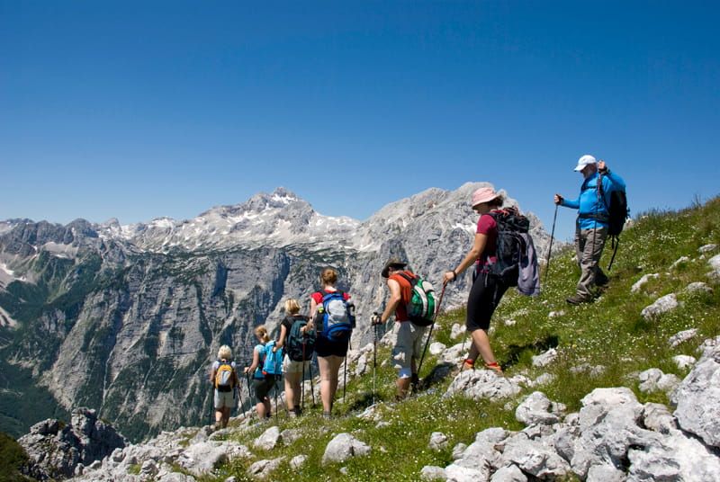Walkers trekking a mountain on a group holiday