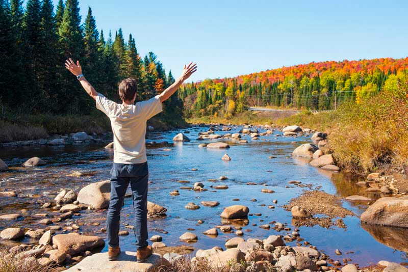 Man admiring the beautiful scenery of New England in the fall