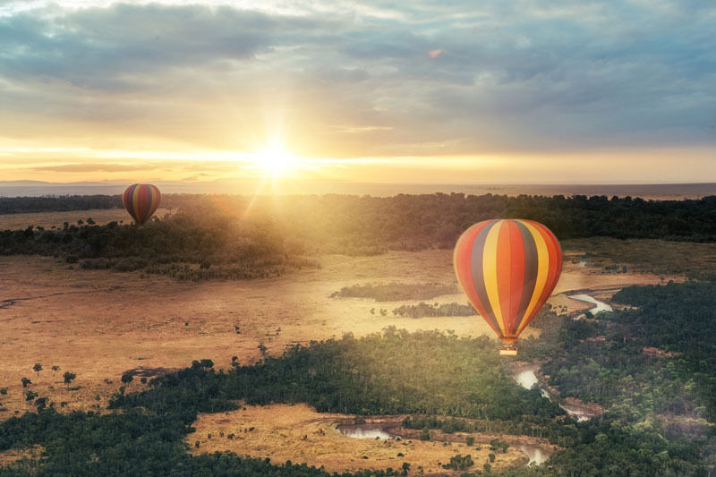 Watching the sunset from a hot air balloon over the Masai Mara plains in Kenya