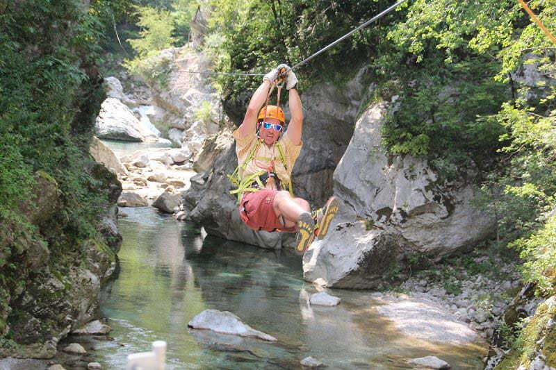 Man ziplining in the Slovenian countryside