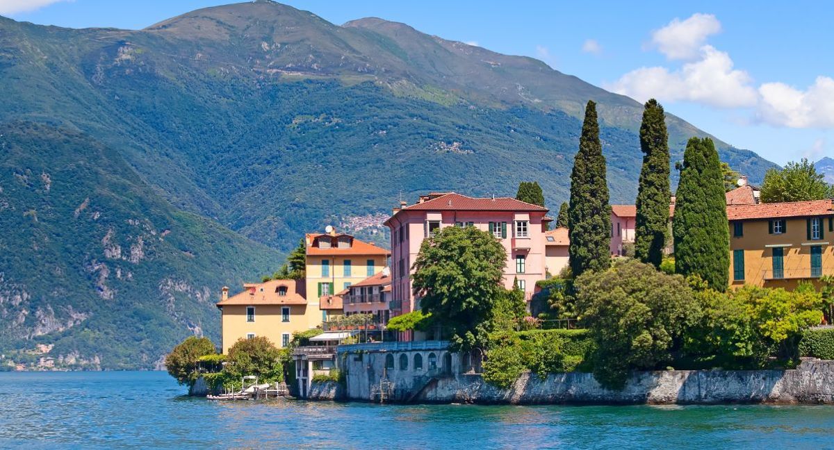 A sunny day in Lake Como overlooking a row of houses.