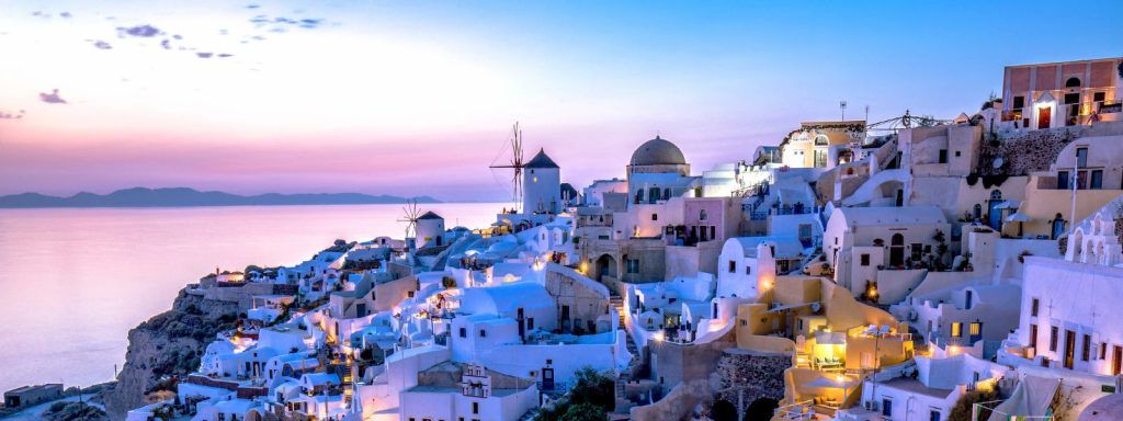 The Sun sets over town in Oia, Greece