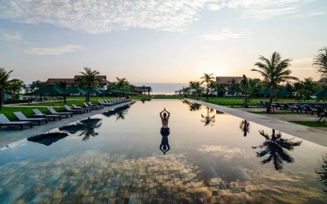 woman in middle of pool in resort